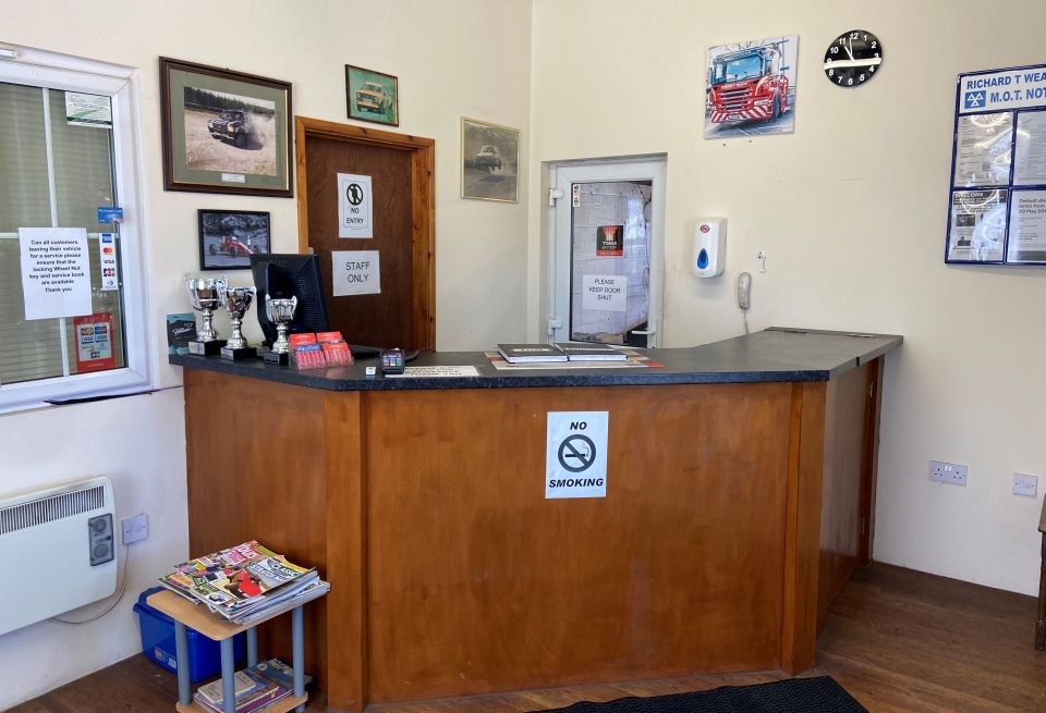 Customer reception at the Bromfield garage, with trophies and framed photos of the recovery truck